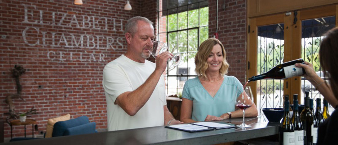A couple enjoying a wine tasting at Elizabeth Chambers Cellar.